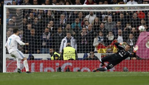 Real Madrid's Cristiano Ronaldo kicks a penalty shot during a Champions League quarter final second leg soccer match between Real Madrid and Juventus at the Santiago Bernabeu stadium in Madrid, Wednesday, April 11, 2018. (AP Photo/Francisco Seco)