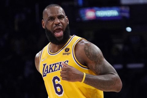 Los Angeles Lakers forward LeBron James celebrates after scoring during the second half of an NBA basketball game against the Dallas Mavericks Tuesday, March 1, 2022, in Los Angeles. (AP Photo/Mark J. Terrill)