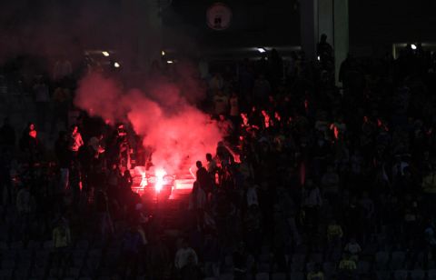 A flare is lit in Cairo Stadium during the first half of a football match between Zamalek and Ismaili clubs in Cairo on February 1, 2012.  At least 73 people were killed in fan violence after a football match between Al-Ahly and Al-Masry clubs in the city of Port Said, the health ministry said, as Egypt struggled with a wave of incidents linked to poor security. AFP PHOTO/MAHMUD HAMS (Photo credit should read MAHMUD HAMS/AFP/Getty Images)