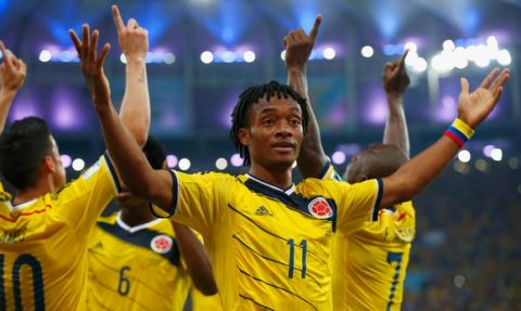 RIO DE JANEIRO, BRAZIL - JUNE 28:  Juan Guillermo Cuadrado of Colombia celebrates his team's second goal scored by James Rodriguez (L) during the 2014 FIFA World Cup Brazil round of 16 match between Colombia and Uruguay at Maracana on June 28, 2014 in Rio de Janeiro, Brazil.  (Photo by Clive Rose/Getty Images)