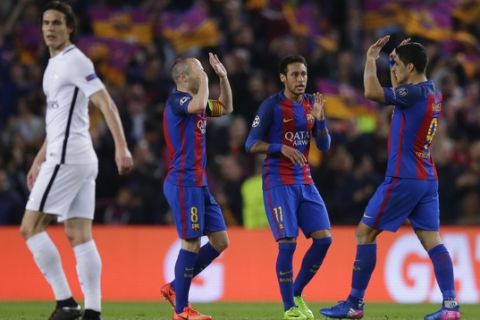 Barcelona's Andres Iniesta, 2nd left, celebrates with Neymar and Luis Suarez after PSG's Layvin Kurzawa scored an own goal during the Champion's League round of 16, second leg soccer match between FC Barcelona and Paris Saint Germain at the Camp Nou stadium in Barcelona, Spain, Wednesday March 8, 2017. (AP Photo/Manu Fernandez)