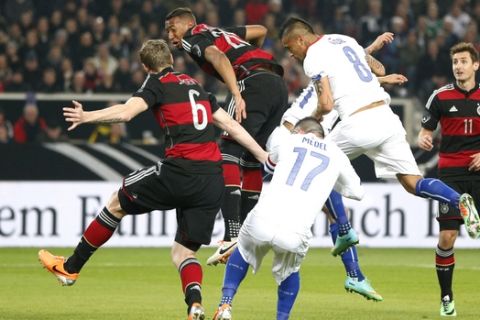 Chile's Arturo Vidal (8)  challenges  for the ball during the international friendly soccer match between Germany and Chile in Stuttgart, Germany, Wednesday, March 5, 2014. (AP Photo/Matthias Schrader)