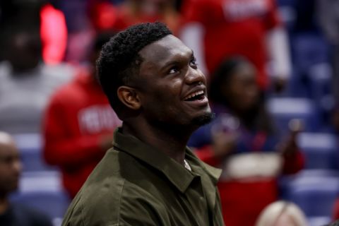 New Orleans Pelicans forward Zion Williamson stands by the bench during introductions prior to tip off of an NBA basketball game against the Charlotte Hornets in New Orleans, Friday, March 11, 2022. (AP Photo/Derick Hingle)