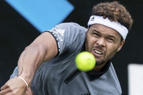 Jo-Wilfried Tsonga serves the ball to Mischa Zverev during their first round match at the ATP tennis tournament in Stuttgart, Germany, Monday, June 10, 2019. (Silas Stein/dpa via AP)