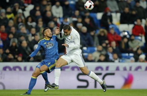 Celta's Theo Bongonda, left, and Real Madrid's Danilo challenge for the ball during a Copa del Rey quarterfinal, 1st leg soccer match between Real Madrid and Celta at the Santiago Bernabeu stadium in Madrid, Spain Wednesday Jan. 18, 2017. (AP Photo/Paul White)