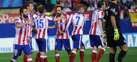 MADRID, SPAIN - OCTOBER 01:  Arda Turan (L) of Club Atletico de Madrid celebrates with teammates after scoring his team's opening goal during the UEFA Champions League Group A match between Club Atletico de Madrid and Juventus at Vicente Calderon Stadium on October 1, 2014 in Madrid, Spain.  (Photo by Denis Doyle/Getty Images)