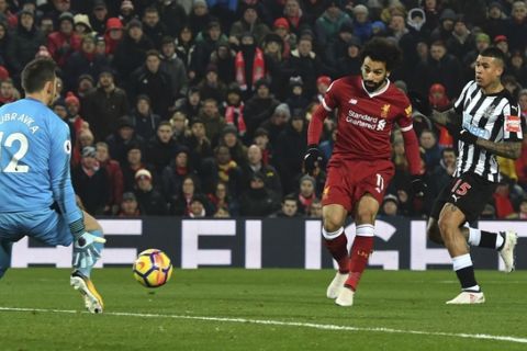 Liverpool's Mohamed Salah scores his side's first goal of the game, during the English Premier League soccer match between Liverpool and Newcastle United, at Anfield, in Liverpool, England, Saturday March 3, 2018. (Anthony Devlin/PA via AP)