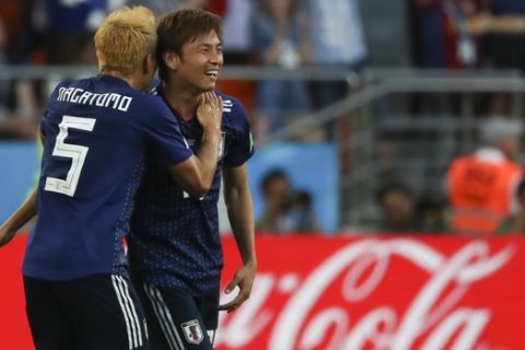 Japan's Takashi Inui, right, celebrates with teammate Yuto Nagatomo after scoring his side's first goal during the group H match between Japan and Senegal at the 2018 soccer World Cup at the Yekaterinburg Arena in Yekaterinburg , Russia, Sunday, June 24, 2018. (AP Photo/Eugene Hoshiko)