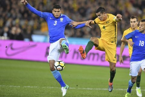 Brazil's Thiago Silva, left and Australia's Tim Cahill, right contest the ball during heir soccer friendly match in Melbourne, Australia, Tuesday, June.13, 2017. ( AP Photo/Andy Brownbill)