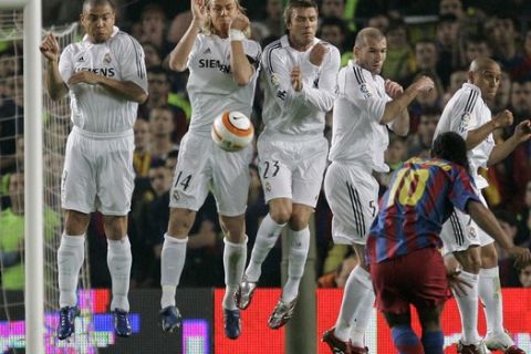 Real Madrid players, Ronaldo, left, from Brazil, Guti, second left, from Spain, Englands David Beckham, third left, Zinedine Zidane, second right, from France and Roberto Carlos, right, from Brazil block a shot from FC Barcelona player Ronaldinho, bottem right, from Brazil during their Spanish League soccer match at the Camp Nou stadium in Barcelona, Spain, Saturday, April 1, 2006. The match ended in a 1-1 draw. (AP Photo/Jasper Juinen) **EFE OUT **