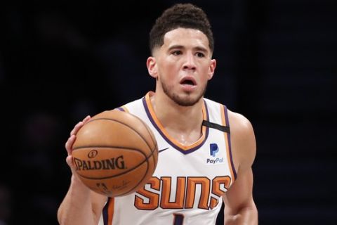 Phoenix Suns guard Devin Booker (1) takes the ball down court during the second half of an NBA basketball game, Monday, Feb. 3, 2020, in New York. The Nets defeated the Suns 119-97. (AP Photo/Kathy Willens)