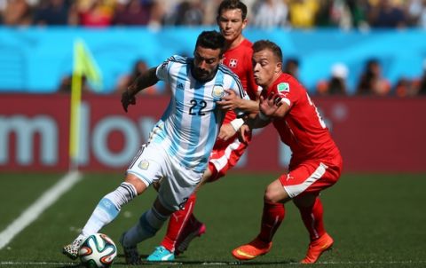 SAO PAULO, BRAZIL - JULY 01: Ezequiel Lavezzi of Argentina is challenged by Xherdan Shaqiri of Switzerland during the 2014 FIFA World Cup Brazil Round of 16 match between Argentina and Switzerland at Arena de Sao Paulo on July 1, 2014 in Sao Paulo, Brazil.  (Photo by Julian Finney/Getty Images)