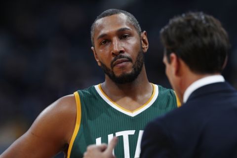 Utah Jazz center Boris Diaw (33), back, confers with Utah Jazz head coach Quin Snyder in the second half of an NBA basketball game Tuesday, Jan. 24, 2017, in Denver. The Nuggets won 103-93. (AP Photo/David Zalubowski)