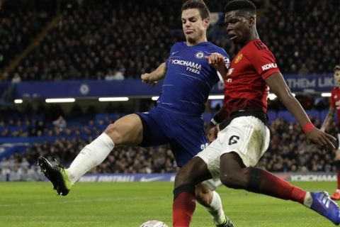 Chelsea's Cesar Azpilicueta, left, challenges for the ball with Manchester United's Paul Pogba during the English FA Cup fifth round soccer match between Chelsea and Manchester United at Stamford Bridge stadium in London, Monday, Feb. 18, 2019. (AP Photo/Matt Dunham)