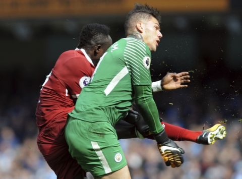 Manchester City's goalkeeper Ederson, right, and Liverpool's Sadio Mane, left, collide during the English Premier League soccer match between Manchester City and Liverpool at the Etihad Stadium in Manchester, England, Saturday, Sept. 9, 2017. (AP Photo/Rui Vieira)