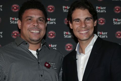 Brazilian former soccer player Ronaldo, left, and tennis player Rafael Nadal, right, of Spain, pose for the photographers prior to a poker match at a casino in central London, Tuesday, Nov. 18, 2014.  According to the organisers, an online poker company, the athletes for the past two months have been in training, after Ronaldo challenged Nadal to the live head-to-head poker match after the two first went head-to-head in December at the European Poker Tour Prague Charity Challenge. Nadal won the match to receive a $ 50,000 donation for the Rafael Nadal Foundation. (AP Photo/Lefteris Pitarakis)