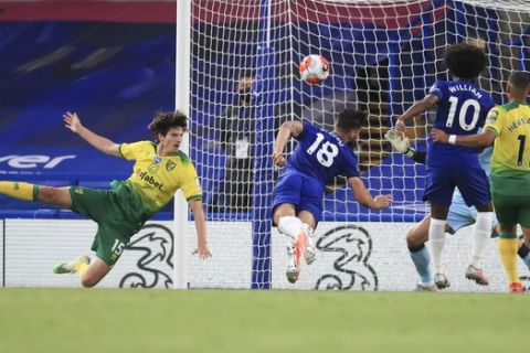 Chelsea's Olivier Giroud, centre, heads the ball into the goal to score his team's first goal during the English Premier League soccer match between Chelsea and Norwich City at Stamford Bridge in London, England, Tuesday, July 14, 2020. (AP Photo/Adam Davy,Pool)