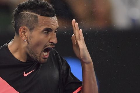 Australia's Nick Kyrgios reacts during his fourth round match against Bulgaria's Grigor Dimitrov at the Australian Open tennis championships in Melbourne, Australia Sunday, Jan. 21, 2018. (AP Photo/Andy Brownbill)