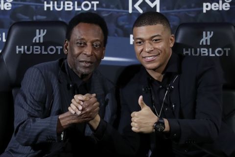 Brazilian soccer legend Pele, left, and French soccer player Kylian Mbappe pose during a photocall in Paris, Tuesday, April 2, 2019. (AP Photo)