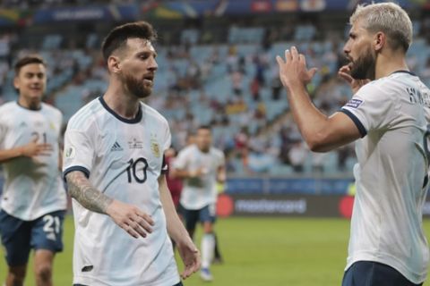 Argentina's Sergio Aguero, right, celebrates with his teammate Lionel Messi after scoring their side's second goal against Qatar during a Copa America Group B soccer match at Arena do Gremio in Porto Alegre, Brazil, Sunday, June 23, 2019. (AP Photo/Silvia Izquierdo)