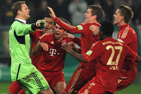 Bayern Munich's goalkeeper Manuel Neuer (L) celebrates with his teammates after their team won the German Football League DFB Cup semi-final match between Borussia Moenchengladbach and Bayern Munich in the western German city of Moenchengladbach on March 21, 2012.  Munich won 4-2 on penalties. 
AFP PHOTO / PATRIK STOLLARZ

RESTRICTIONS / EMBARGO - DFL LIMITS THE USE OF IMAGES ON THE INTERNET TO 15 PICTURES (NO VIDEO-LIKE SEQUENCES) DURING THE MATCH AND PROHIBITS MOBILE (MMS) USE DURING AND FOR FURTHER TWO HOURS AFTER THE MATCH. FOR MORE INFORMATION CONTACT DFL. (Photo credit should read PATRIK STOLLARZ/AFP/Getty Images)
