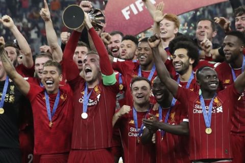 Players of Liverpool celebrate after winning the Club World Cup final soccer match between Liverpool and Flamengo at Khalifa International Stadium in Doha, Qatar, Saturday, Dec. 21, 2019. (AP Photo/Hassan Ammar)