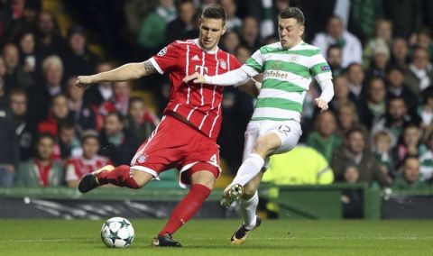 Bayern Munich's Niklas Sule, left, and Celtic's Callum McGregor battle for the ball during the Champions League group B match between Celtic FC and FC Bayern Munich at Celtic Park, Glasgow, Tuesday Oct. 31, 2017. (Andrew Milligan/PA via AP)