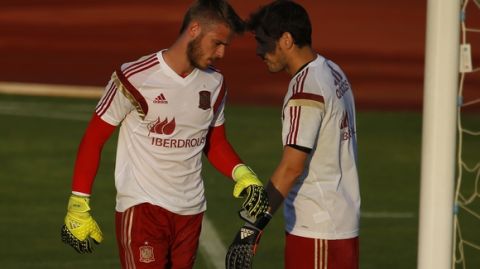 Spain's goalkeeper David de Gea, left, walks past teammate and also goalkeeper Iker Casillas during a training session with the Spanish national team in Las Rozas on the outskirts of Madrid, Spain, Wednesday Sept. 2, 2015. In a surreal ending to the transfer window in Spain, the much-anticipated move of Manchester United goalkeeper David de Gea to Real Madrid never materialized. The clubs had struck a deal that would see Madrid goalkeeper Keylor Navas move the other way, but it broke down because the necessary paperwork wasn't submitted on time. (AP Photo/Francisco Seco)