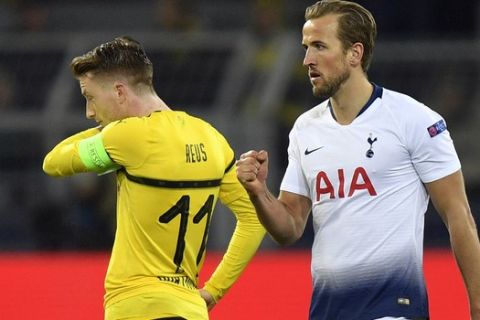 Tottenham forward Harry Kane, right, celebrates after scoring the opening goal during the Champions League round of 16, 2nd leg, soccer match between Borussia Dortmund and Tottenham Hotspur at the BVB stadium in Dortmund, Germany, Tuesday, March 5, 2019. (AP Photo/Martin Meissner)