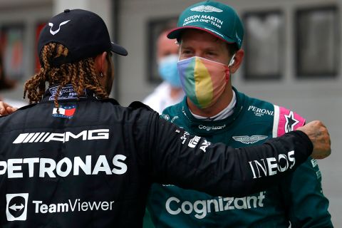 Third placed, Mercedes driver Lewis Hamilton of Britain, left, hugs with second placed Aston Martin driver Sebastian Vettel of Germany after the Hungarian Formula One Grand Prix, at the Hungaroring racetrack in Mogyorod, Hungary, Sunday, Aug. 1, 2021. (Florion Goga/Pool via AP)