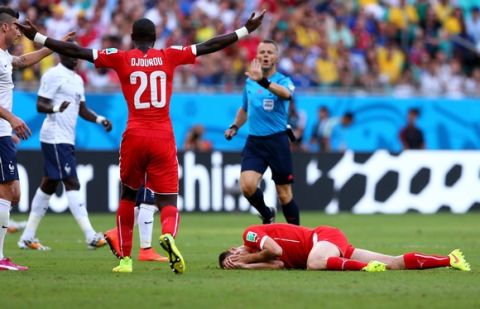 SALVADOR, BRAZIL - JUNE 20:  Steve von Bergen of Switzerland lies on the pitch after a collision during the 2014 FIFA World Cup Brazil Group E match between Switzerland and France at Arena Fonte Nova on June 20, 2014 in Salvador, Brazil.  (Photo by Elsa/Getty Images)