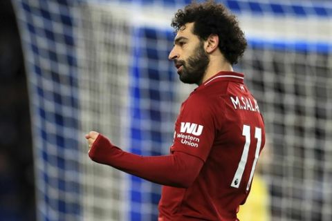 Liverpool's Mohamed Salah celebrates scoring his side's first goal of the game during the English Premier League soccer match between Brighton and Hove Albion and Liverpool F.C at the Vitality Stadium, Brighton England. Saturday, Jan. 12, 2019. (Gareth Fuller/PA via AP)