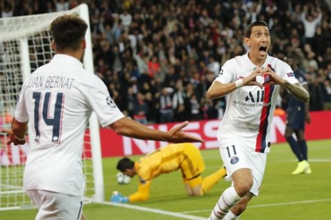 PSG's Angel Di Maria, right, celebrates after scoring his side's opening goal during the Champions League group A soccer match between PSG and Real Madrid at the Parc des Princes stadium in Paris, Wednesday, Sept. 18, 2019. (AP Photo/Francois Mori)