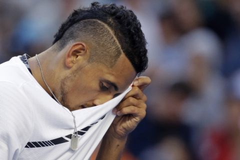 Australia's Nick Kyrgios wipes his face while playing Italy's Andreas Seppi during their second round match at the Australian Open tennis championships in Melbourne, Australia, Wednesday, Jan. 18, 2017. (AP Photo/Aaron Favila)