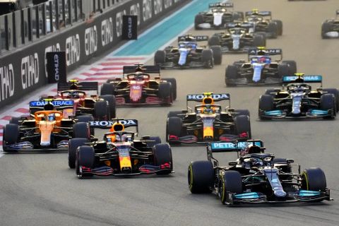 Mercedes driver Lewis Hamilton of Britain in leads Red Bull driver Max Verstappen of the Netherlands at the start of the Formula One Abu Dhabi Grand Prix in Abu Dhabi, United Arab Emirates, Sunday, Dec. 12. 2021. Max Verstappen ripped a record eighth title away from Lewis Hamilton with a pass on the final lap of the Abu Dhabi GP to close one of the most thrilling Formula One seasons in years as the first Dutch world champion. (AP Photo/Hassan Ammar)