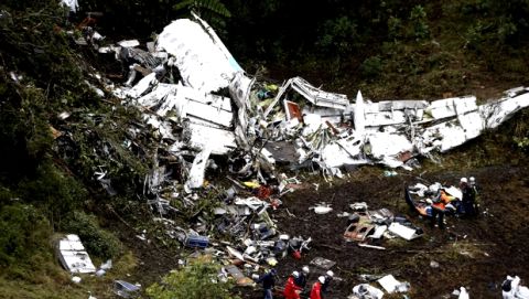 FILE - In this Nov. 29, 2016 file photo, rescue workers recover a body from the wreckage site of an airplane crash, in La Union, a mountainous area near Medellin, Colombia. A LaMia jet carrying 77 people slammed into the Colombian mountainside just minutes after the pilot reported running out of fuel. The crash killed 71 of 77 aboard, including members of Brazil's Chapecoense soccer team and a group of journalists who were traveling to the Copa Sudamericana finals. (AP Photo/Fernando Vergara, File)