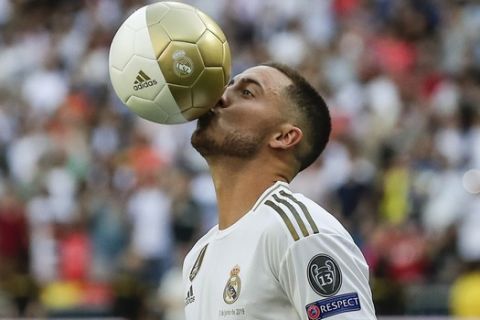 Belgium forward Eden Hazard kisses the ball during his official presentation after signing for Real Madrid at the Santiago Bernabeu stadium in Madrid, Spain, Thursday, June 13, 2019. Real Madrid announced last week that it had acquired the 28-year-old Belgian playmaker from Chelsea for a reported fee of around 100 million euros ($113 million) plus variables, making him the club's most expensive signing ever. (AP Photo/Manu Fernandez)