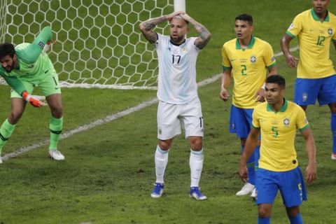 Argentina's Nicolas Otamendi, center, reacts after a teammate missing a chance to score against Brazil during a Copa America semifinal soccer match at the Mineirao stadium in Belo Horizonte, Brazil, Tuesday, July 2, 2019. (AP Photo/Nelson Antoine)