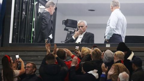 Jose Mourinho, centre, acknowledges fans as he sits in a TV studio during the English Premier League soccer match between Manchester United and Liverpool, at Old Trafford in Manchester, England, Sunday Oct. 20, 2019. (Martin Rickett/PA via AP)