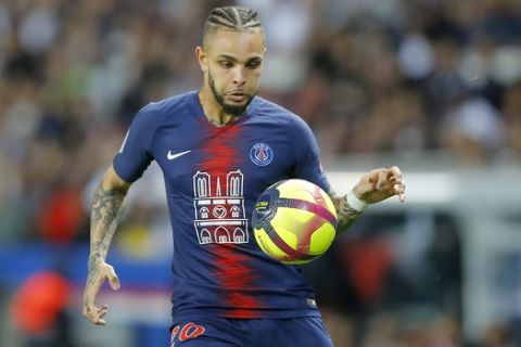 PSG's Layvin Kurzawa, bearing an image of Notre Dame cathedral on his jersey, runs with the ball during the French League One soccer match between Paris-Saint-Germain and Monaco at the Parc des Princes stadium in Paris, Sunday April 21, 2019. The efforts of Paris firefighters in tackling the blaze at Notre Dame cathedral were being recognized at the match. (AP Photo/Michel Euler)