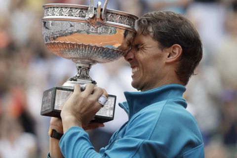 Spain's Rafael Nadal lifts the trophy as he celebrates winning the men's final match of the French Open tennis tournament against Austria's Dominic Thiem in three sets 6-4, 6-3, 6-2, at the Roland Garros stadium in Paris, France, Sunday, June 10, 2018. (AP Photo/Alessandra Tarantino)