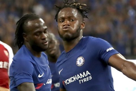 Chelsea's Michy Batshuayi, foreground, celebrates with teammate Victor Moses after scoring a goal during the first half of their friendly soccer match against Arsenal in Beijing, Saturday, July 22, 2017. (AP Photo/Mark Schiefelbein)