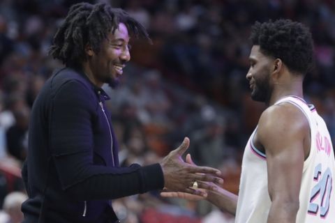 Former NBA basketball player Amar'e Stoudemire, left, greets Miami Heat's Justise Winslow (20) during the first half of an NBA basketball game between the Miami Heat and Phoenix Suns, Monday, March 5, 2018, in Miami. (AP Photo/Lynne Sladky)