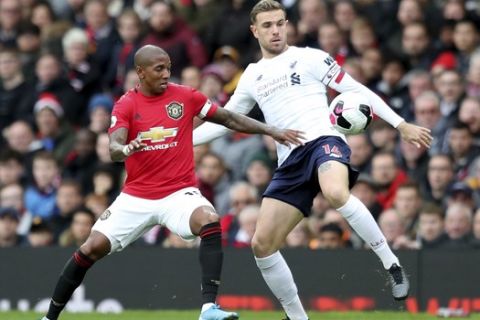 Manchester United's Ashley Young, left, fights for the ball with Liverpool's Jordan Henderson during the English Premier League soccer match between Manchester United and Liverpool at the Old Trafford stadium in Manchester, England, Sunday, Oct. 20, 2019. (AP Photo/Jon Super)
