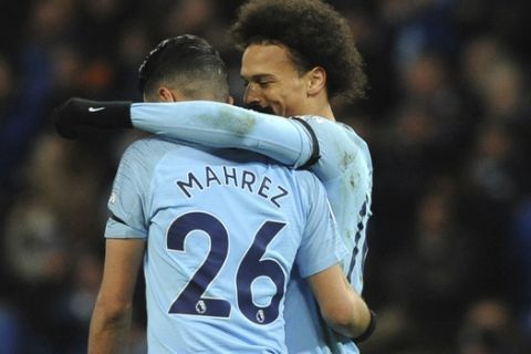 Manchester City's Leroy Sane, right, celebrates with teammate Riyad Mahrez after scoring his side's second goal during the English Premier League soccer match between Manchester City and Cardiff City at Etihad stadium in Manchester, England, Wednesday, April 3, 2019. (AP Photo/Rui Vieira)