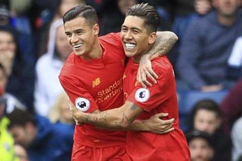 Liverpool's Roberto Firmino, right, celebrates with teammate Philippe Coutinho after scoring his side's first goal during their English Premier League soccer match against West Bromwich Albion at The Hawthorns, West Bromwich, England, Sunday, April 16, 2017. (Adam Davy/PA via AP)