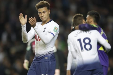 Tottenham's Dele Alli applauds after wining in penalties during the English League Cup soccer match between Tottenham Hotspur and Watford at Stadium MK in Milton Keynes, England, Wednesday, Sept. 26, 2018. (AP Photo/Kirsty Wigglesworth)