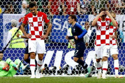 Croatia's Luka Modric, right, and Croatia's Dejan Lovren, left, react after France's Paul Pogba, not in picture, scored his side's third goal during the final match between France and Croatia at the 2018 soccer World Cup in the Luzhniki Stadium in Moscow, Russia, Sunday, July 15, 2018. (AP Photo/Matthias Schrader)