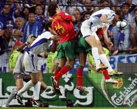 Greece's forward Angelos Charisteas (R) heads the ball in to score against Portugal, 04 July 2004 at the Luz stadium in Lisbon, during the Euro 2004 final match between Portugal and Greece at the European Nations football championship in Portugal. AFP PHOTO Franck FIFE (Photo credit should read FRANCK FIFE/AFP/Getty Images)