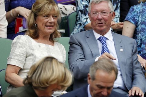 Former football manager Sir Alex Ferguson, right, sits in the Royal Box on day twelve of the Wimbledon Tennis Championships in London, Friday, July 8, 2016. (AP Photo/Ben Curtis)